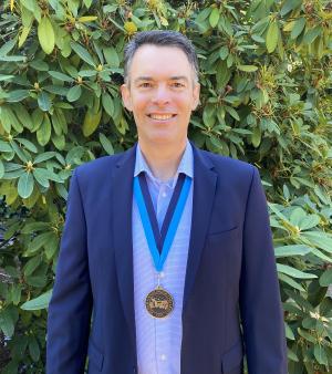 David Sattler wearing WWU award medallion