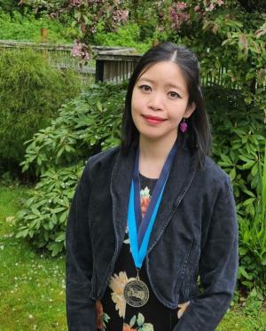 Jane Wong wearing a WWU award medallion