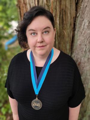 Terri Kempton wearing a WWU award medallion