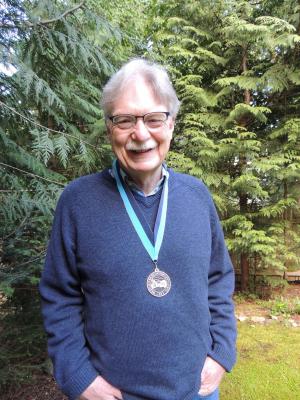 Wayne Landis wearing WWU award medallion