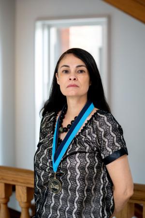 Dolores Calderón wearing WWU award medallion