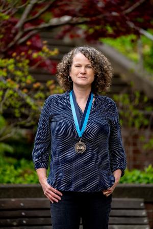 Erika McPhee-Shaw wearing a WWU award medallion
