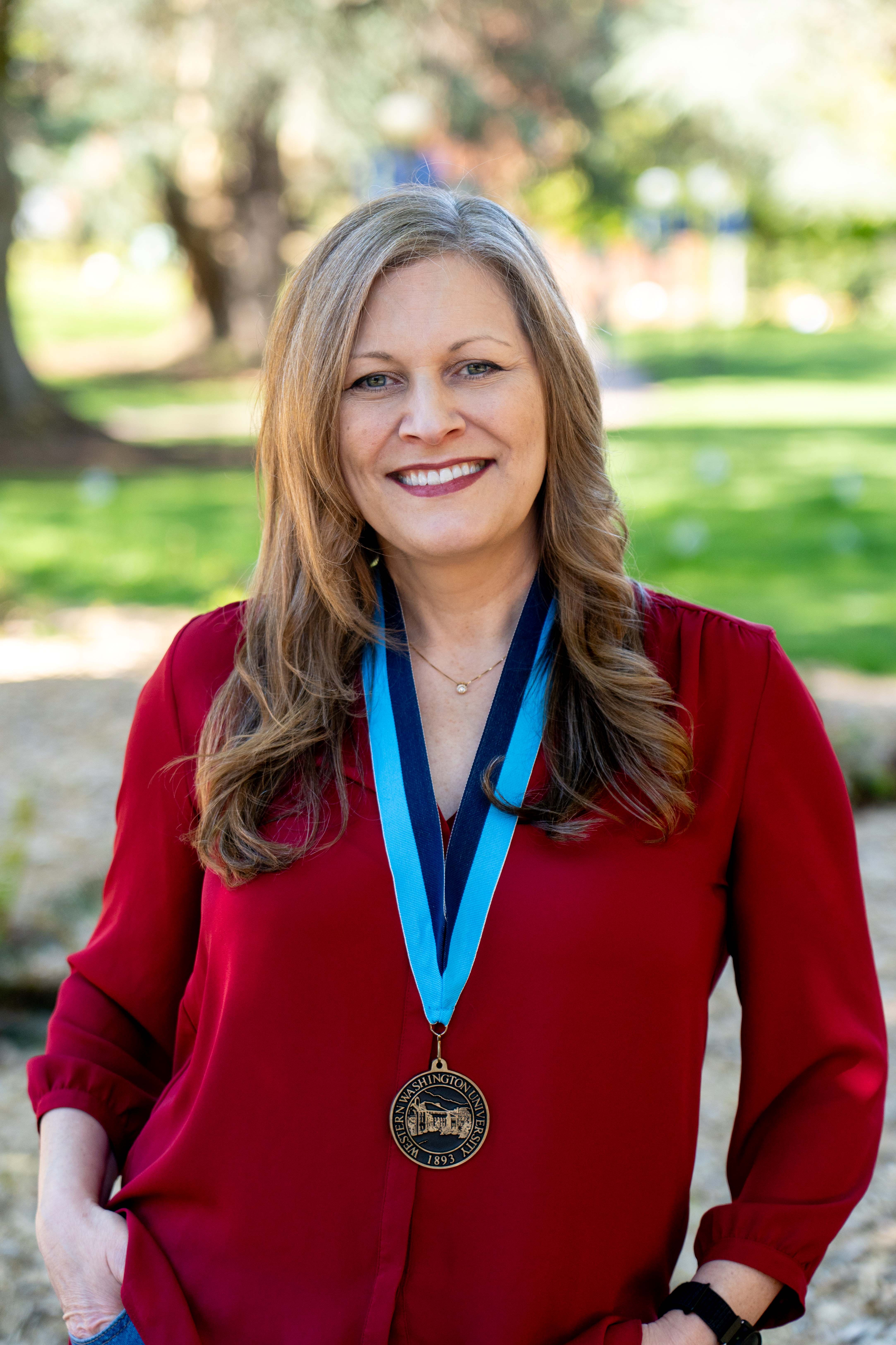 Dr. Karen Stout smiling confidently wearing a WWU award medallion