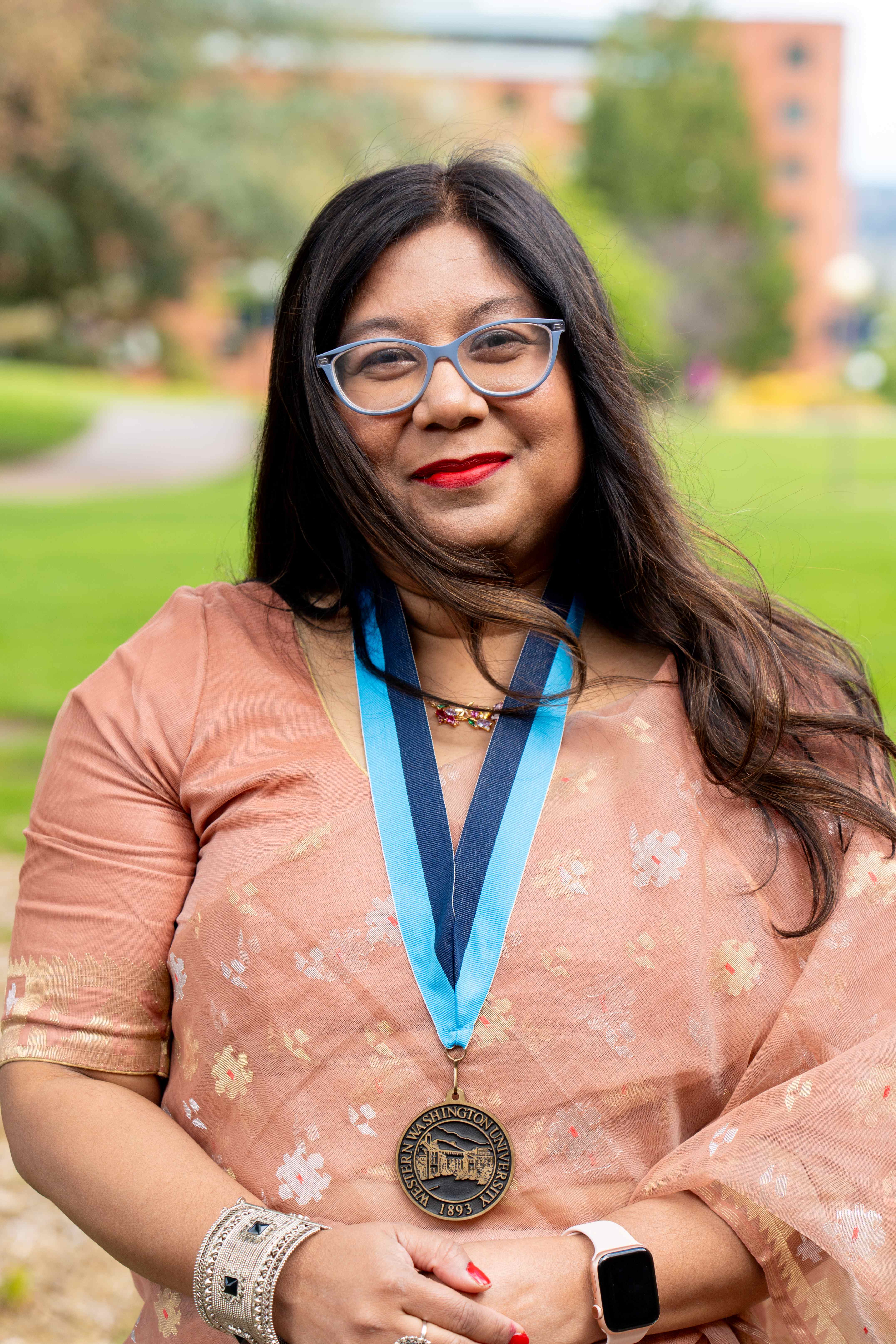 Dr. Moushumi Sharmin wearing a beautiful saree dress and the WWU award medallion
